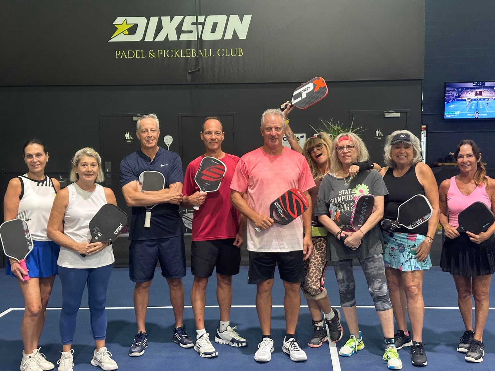 Pickleball players on court with their paddles